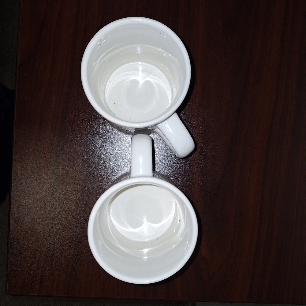 A pair of Naughty and Nice coffee mugs. Dishwasher and microwave safe.